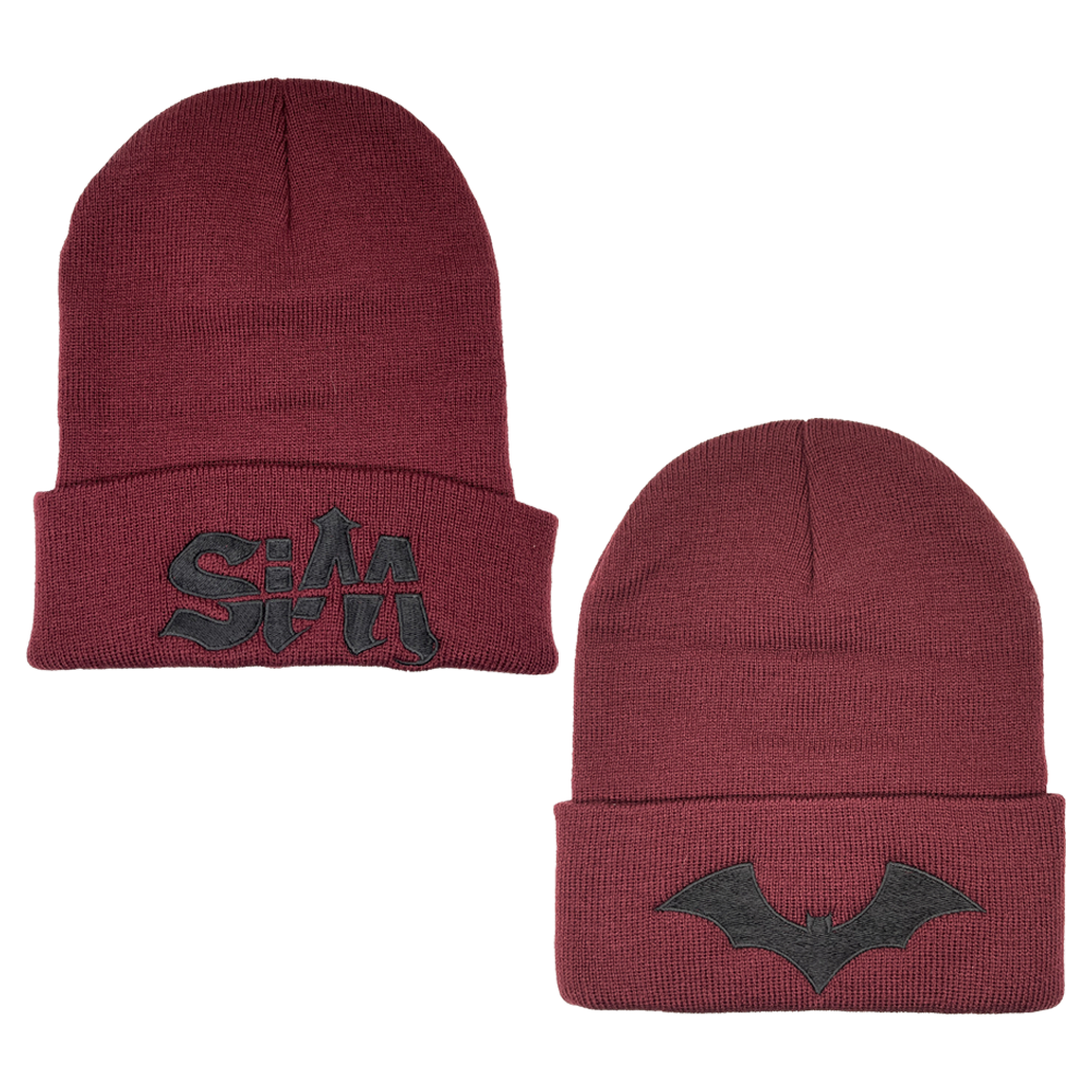 A maroon red beanie with embroidered SIM logo and bat design. 